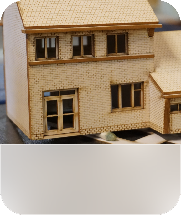 A model house made of laser-cut wooden parts.