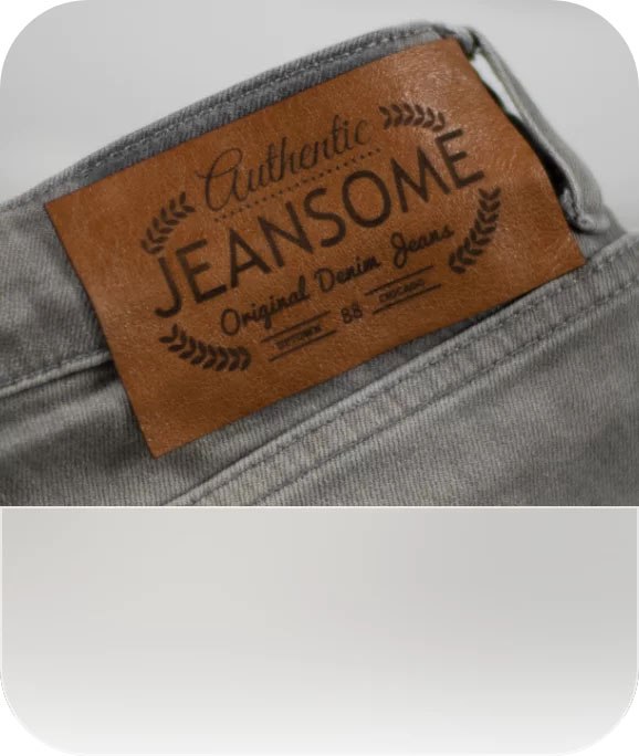 A laser-engraved logo on the back of a pair of jeans.