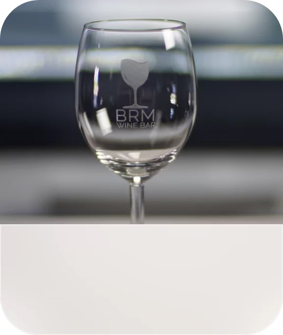 An engraved glass with a logo of a bar.